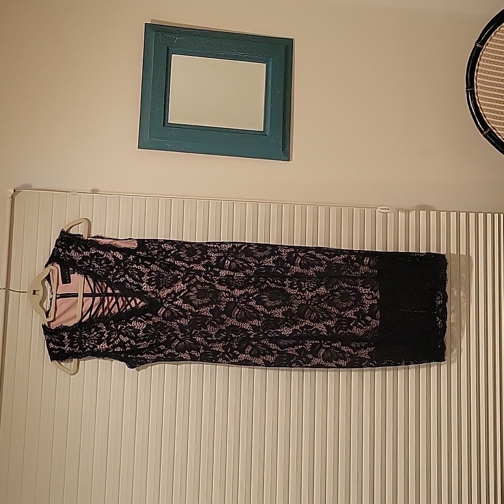 Sixe 12 black lace dress with nude background and sheer hemline.